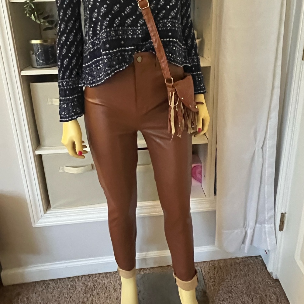 I am selling brown leather pants that have a soft feel on the inside.
